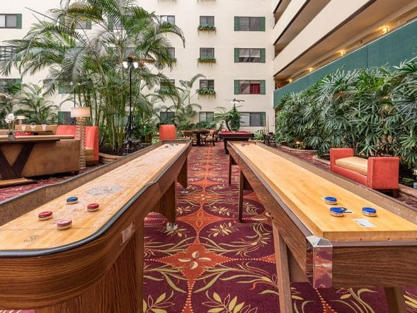 Tabletop shuffleboard tables in the The Meridian at Westwood lobby area