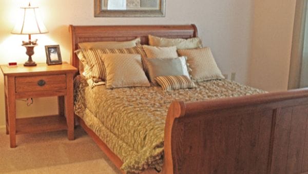 The Forum at Desert Harbor model bedroom with a sleigh bed
