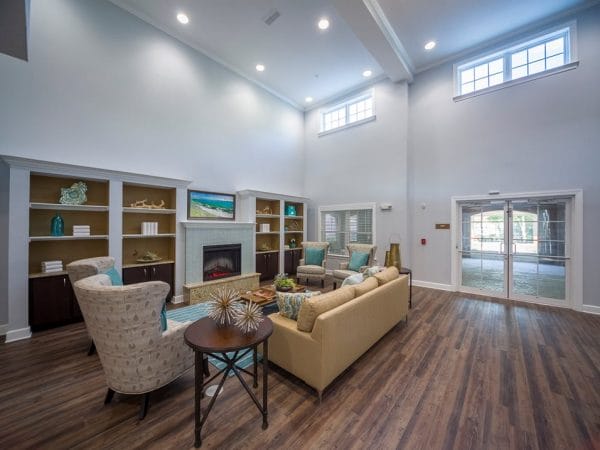 Resident community living room with vaulted ceilings and wood floors at Peyton Ridge Apartments