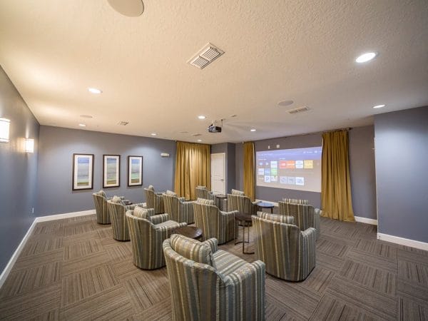 Movie theater with individual upholstered chairs for residents of Peyton Ridge Apartments