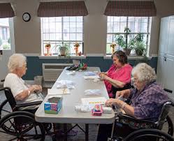 Peak Resources Brookshire residents doing crafts at a long table