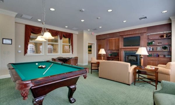 Entertainment room inside Waltonwood Cary Parkway with pool table