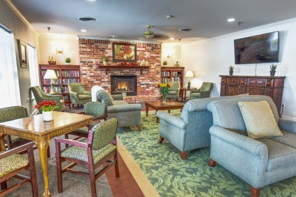 Community living room with brick fireplace in The Renaissance of Florence