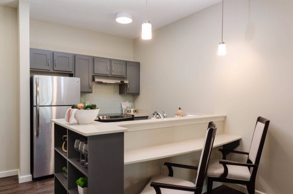 Inside a residents kitchen area with breakfast bar at American House Coconut Point