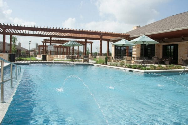 Outdoor swimming pool surrounded by trellisses and seating areas at Rio Terra
