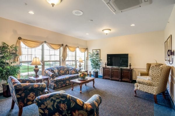 Rittenhouse Village At Portage community living room with plush sofas and television