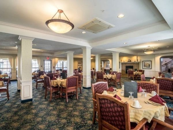 Large dining room with comfortable arm chairs for residents of Rittenhouse Village At Portage