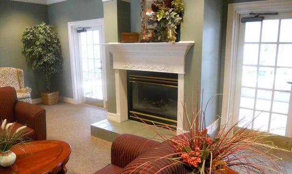 Savannah Court of Bartow fireplace with white mantel and flowers on top