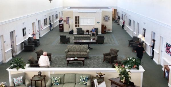 Aerial view of indoor common area with many seating areas for Savannah Grand of Amelia Island residents