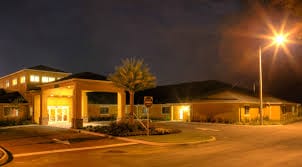 The front entrance at night with covered driveway at Superior Residences of Clermont