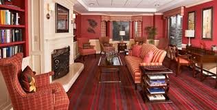 Rich interior living space at The Bristal Assisted Living at East Meadow with sofa facing fireplace