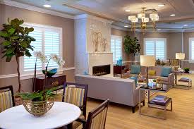 The Bristal Assisted Living at Englewood resident common living room with comfortable seating around large fireplace