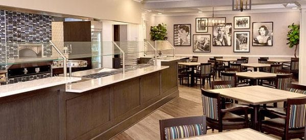The Bristal Assisted Living at Englewood dining room with long glass covered buffet and seating for residents