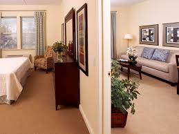 Model apartment at The Bristal Assisted Living at North Woodmere with split view into both the bedroom and living room