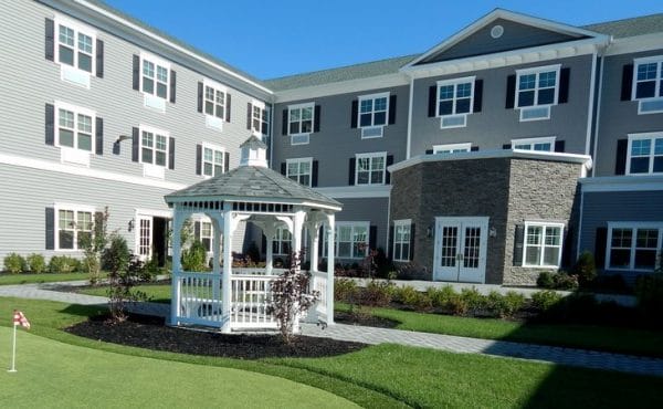 Courtyard and gardens with a gazebo and walking trails at The Bristal Assisted Living at West Babylon