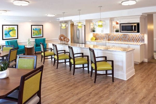The Bristal Assisted Living at Westbury coomunity kitchen with breakfast bar and tables