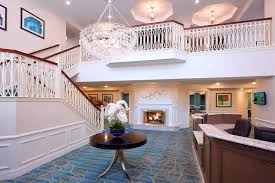 Lobby of The Bristal Assisted Living at Westbury with reception area and two level staircase leading up to second floor