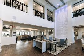 Lobby and common living area with second story balcony looking over lounge at The Capstone at Royal Palm