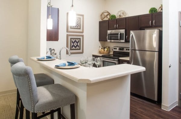 Apartment kitchen with stainless appliances at The Welstone at Mission Crossing