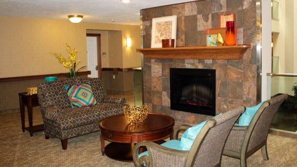 Living room with fireplace at Towne Center Retirement