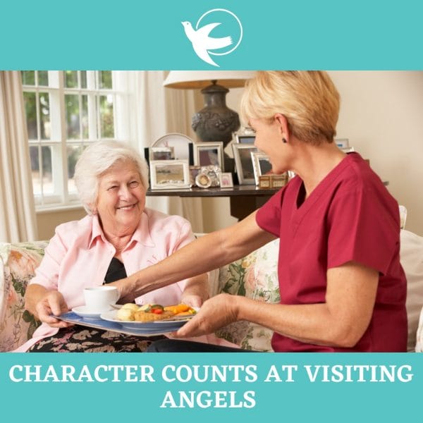 Senior woman being served a tray of food from a Visiting Angels caregiver