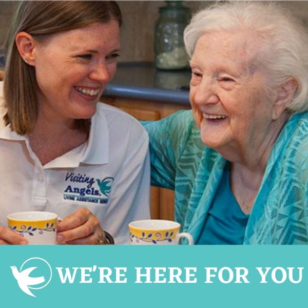 Visiting Angels caregiver having coffee with senior woman smiling
