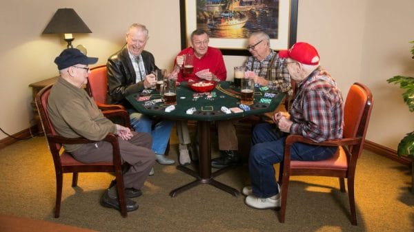 Five senior men playing cards at Walnut Grove Retirement