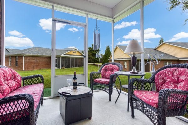 Charter Senior Living of Hermitage patio area with cushioned wicker furniture