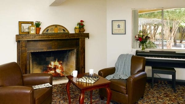 Resident living area with fireplace in Atria Valley Manor