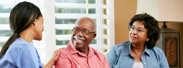 Senior couple laughing with Hand 'N Heart caregiver