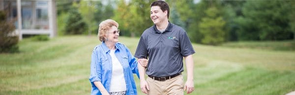 Female woman walking with male First Light Home Care - West Columbia caregiver