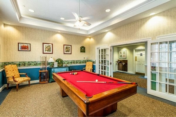 Red felt pool table in the Elison Independent & Assisted Living of Maplewood billiards room
