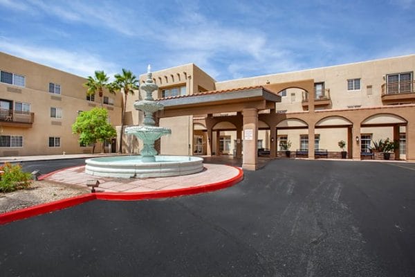 Brookdale Apache Junction entrance and covered driveway with large teired water fountain in front