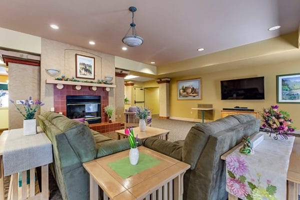 Community living room with large fireplace in Brookdale Apache Junction