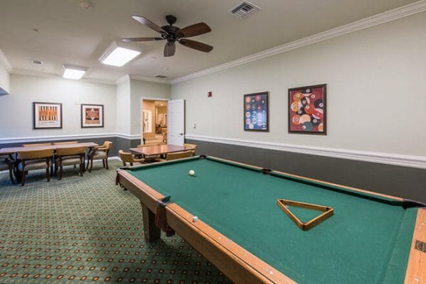 Green felt pool table in the Brookdale College Parkway billiards room