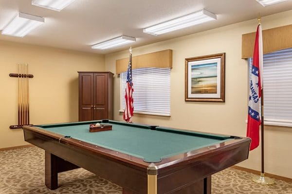 Billiards room in Brookdale Conway with green felt pool table