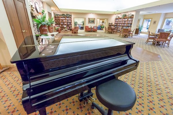 Black grand piano in the common area in Brookdale Paulin Creek