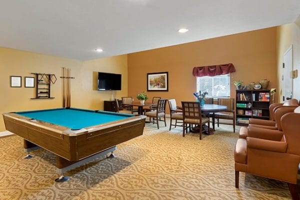 Billiards room with green felt pool table and gaming tables in Brookdale Pleasant Hills