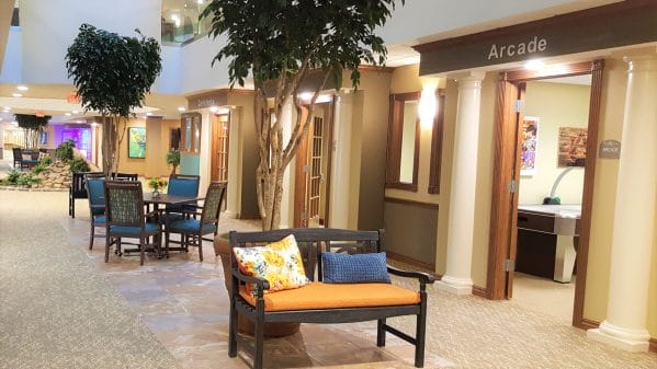 Common area featuring seating and indoor trees at Cahaba Ridge Retirement Community