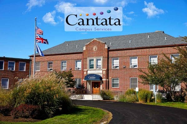 Cantata Senior Living exterior view of front of the brick building on a sunny day
