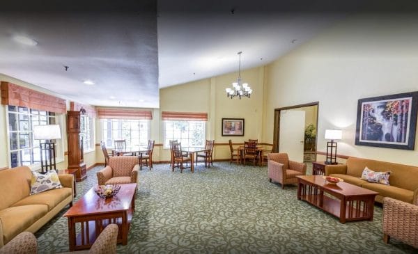 Community living room with chairs and tables at Cypress Court