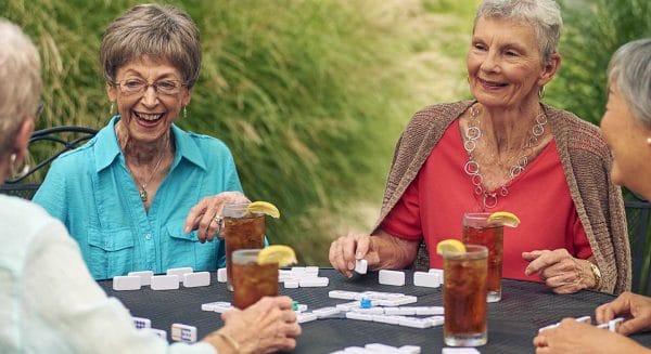 Seniors playing a game and drinking iced tea at Ascension Living Alexian Village Milwaukee
