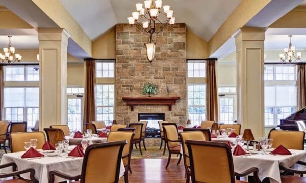 Waltonwood Providence dining room with a large stone fireplace