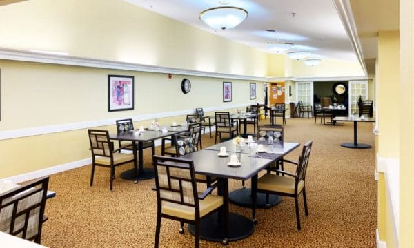 Community dining area with tables and chairs at Lassen House Senior Living