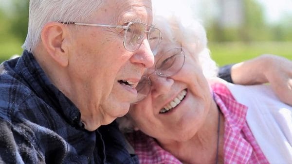Beehive Homes of Green Valley senior couple residents smiling and cuddling