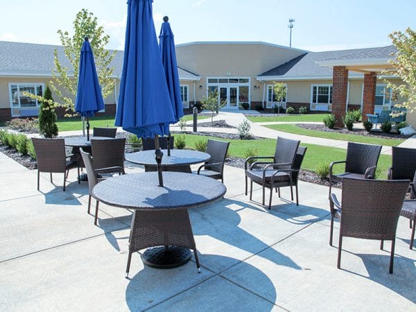 Umbrella tables and outdoor seating at Regency Retirement Village - Huntsville