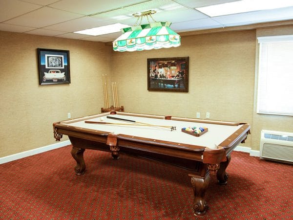 Regency Retirement Village - Huntsville billiards room with tan felt covered pool table