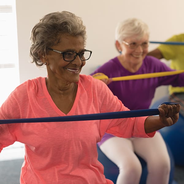 Senior women using stretch bands for exercise at The Pointe