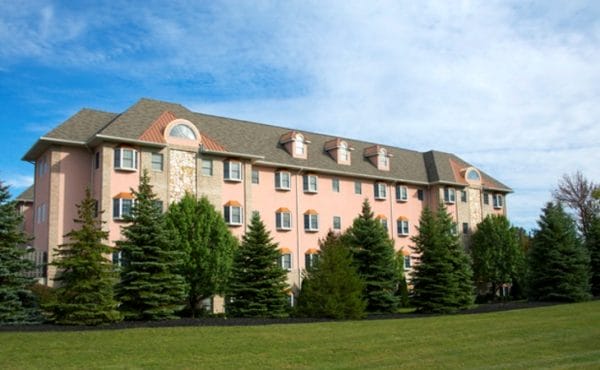 View of building with evergreen trees in front of Generations Senior Living of Strongsville