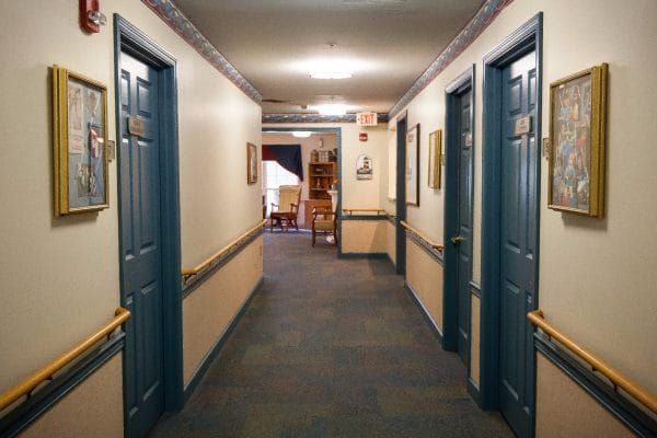 Resident hallway with blue doors at Arden Courts of Largoat